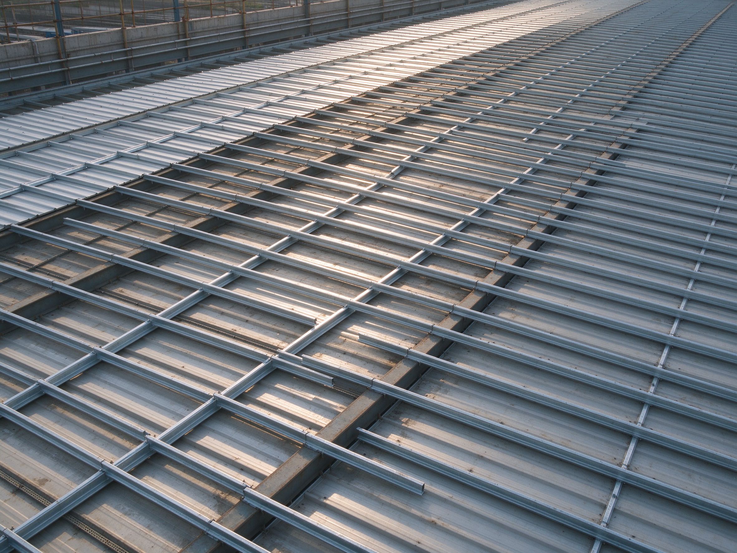 Roof purlin grid viewed from inside, partly sheeted (illustrative concept image)