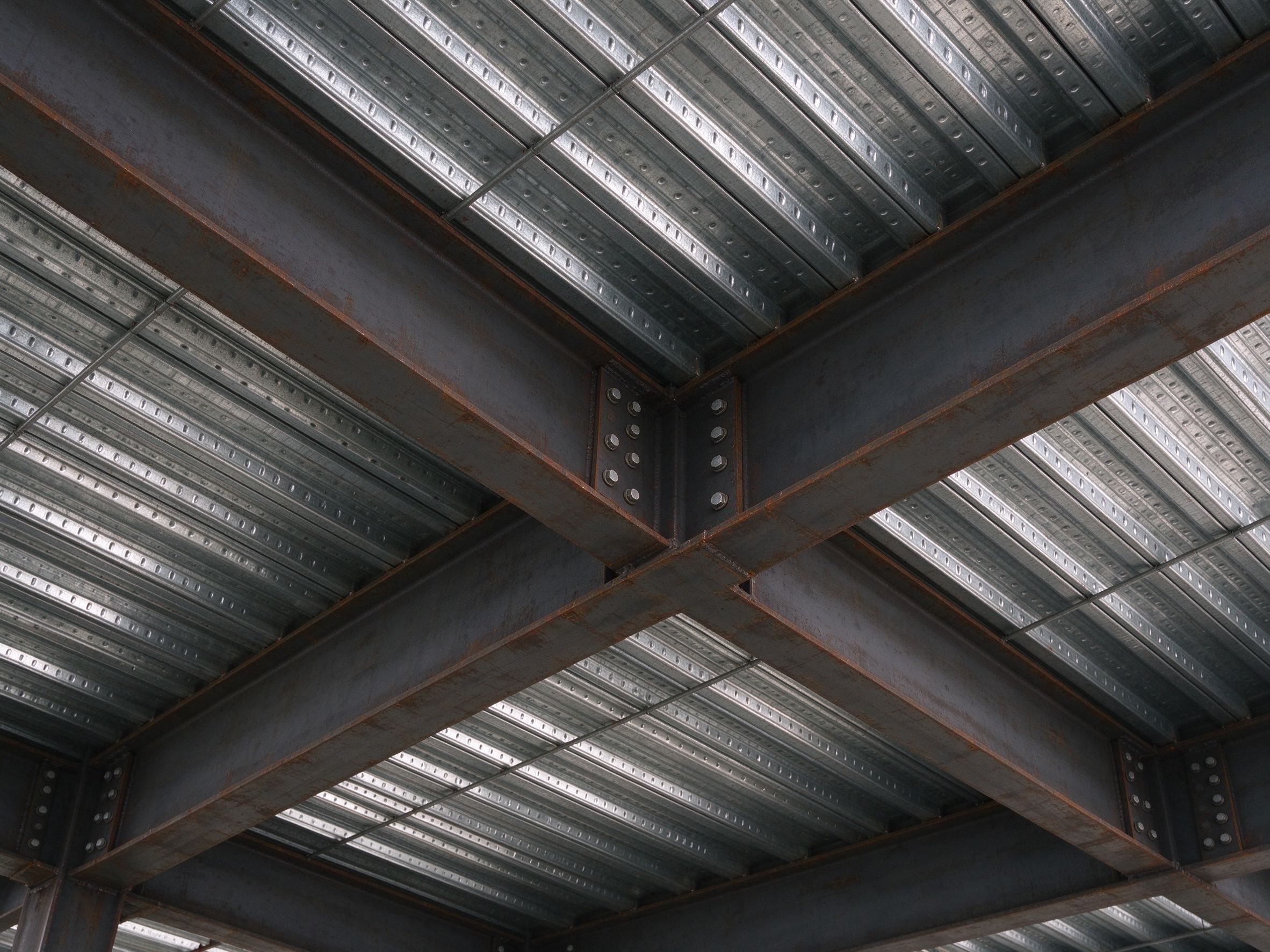 Long-span steel beams and a composite floor seen from below (illustrative concept image)