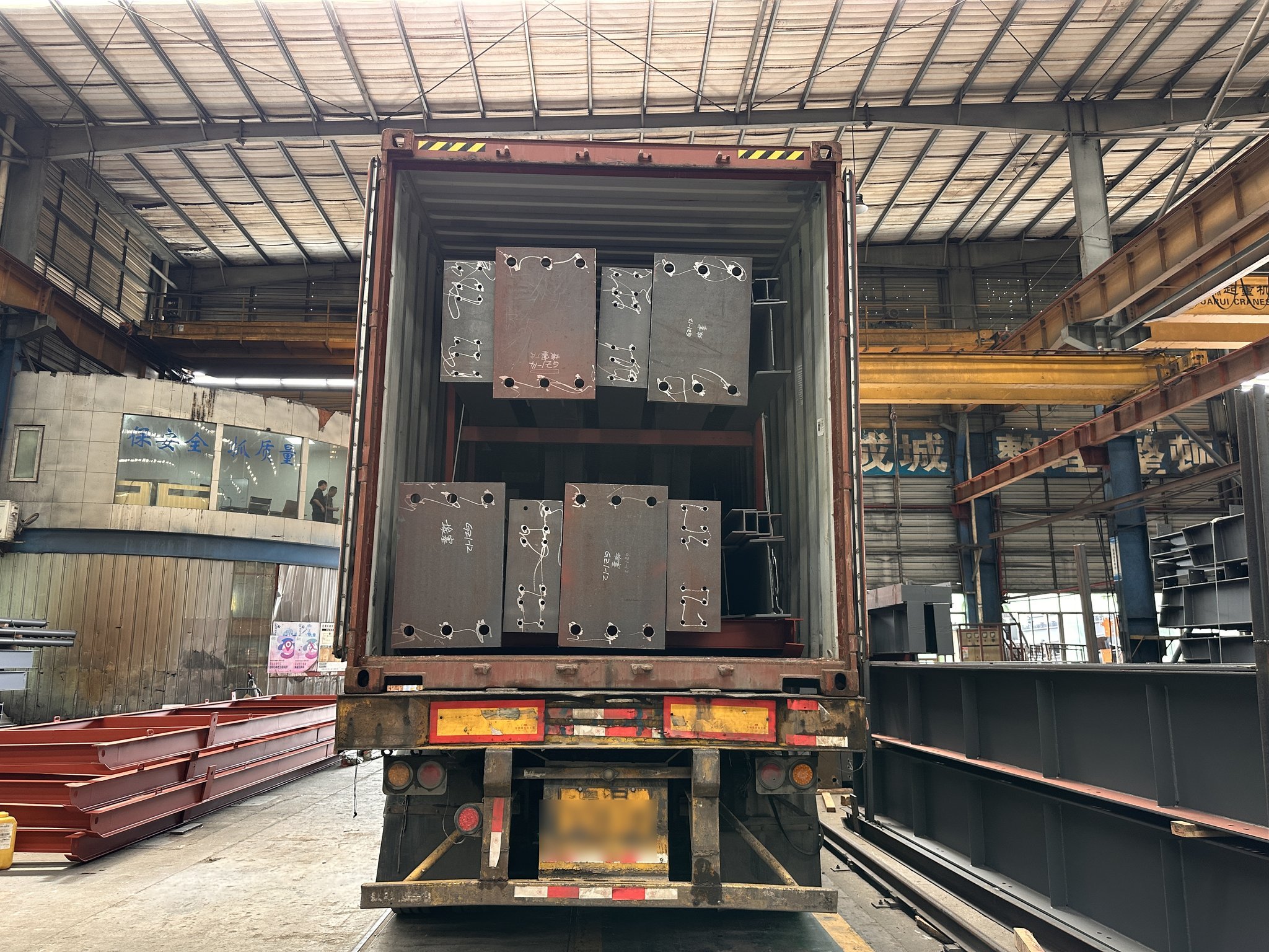 ZhongSai loading marked and packed steel members into a shipping container for export